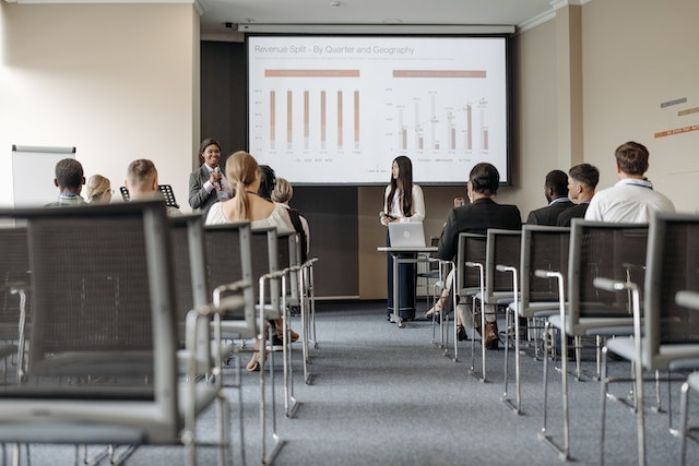 People sitting in a conference room listening to a presentation.