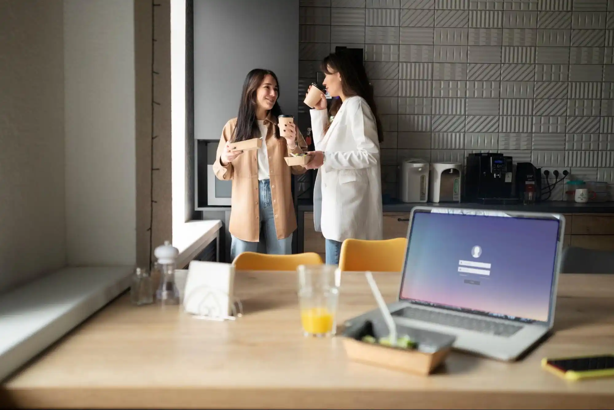 Two women chatting in an office